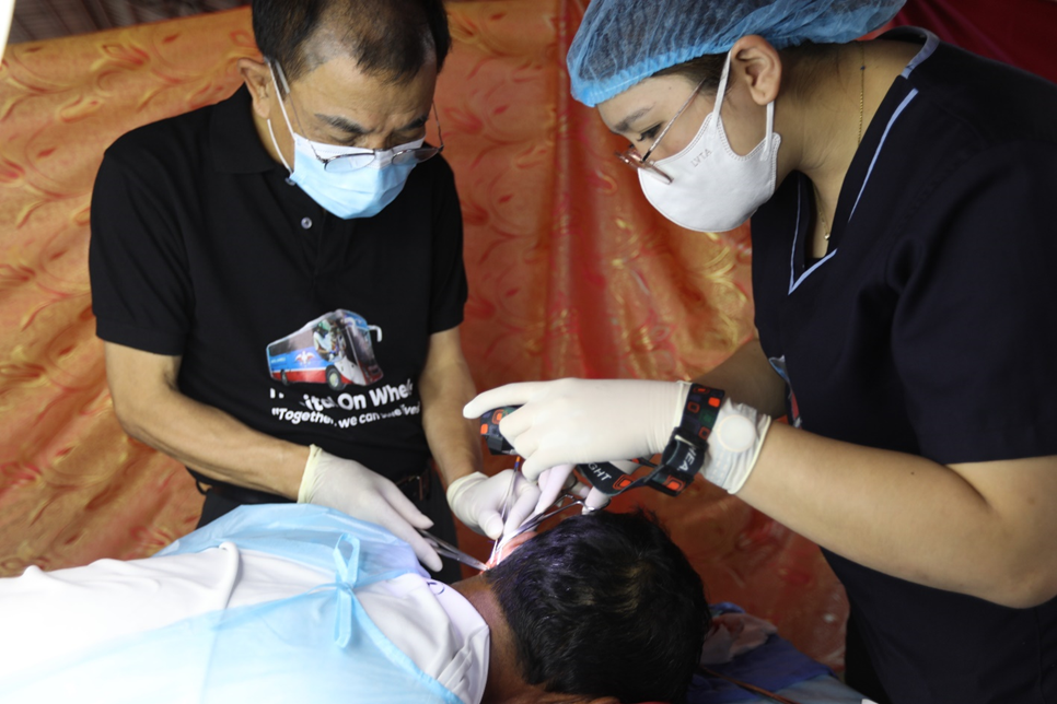 Dr. Jim Sanchez performing a minor surgery on one of the patients.